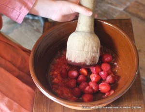 The first step in the preparation of the receipt (recipe) Strawberry Cream is to mash the strawberries. My granddaughter used a wood masher turned by a joyner.