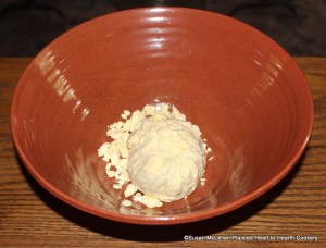 The first step in the preparation of the receipt (recipe) Cheese Loaves is to take cheese curd.  The fresh cheese was prepared by making a rennet tea from a piece of a processed rennet stomach.  The fresh milk was heated to blood warm, rennet tea added, the curd cut and then heated in the whey until the curd squeaked between the molars of your teeth.  The curd and whey was poured through a linen cloth covering a cheese basket and then tied in the cloth for whey to continue to drip away.  The curds are just separated with hands for this receipt.