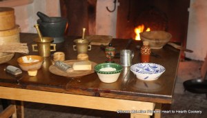 The table is ready for the preparation of the 1685 receipt (recipe) Fritters in the Italian Fashion.  The ingredients include parmisan cheese, flour, bisket bread, eggs, saffron, sugar, cloves, mace, and cream.