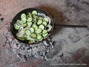 After the cucumbers were sliced and onion peeled and sliced for the receipt (recipe) To stew Cucumbers, mix and put them in a pan with melted butter for frying.